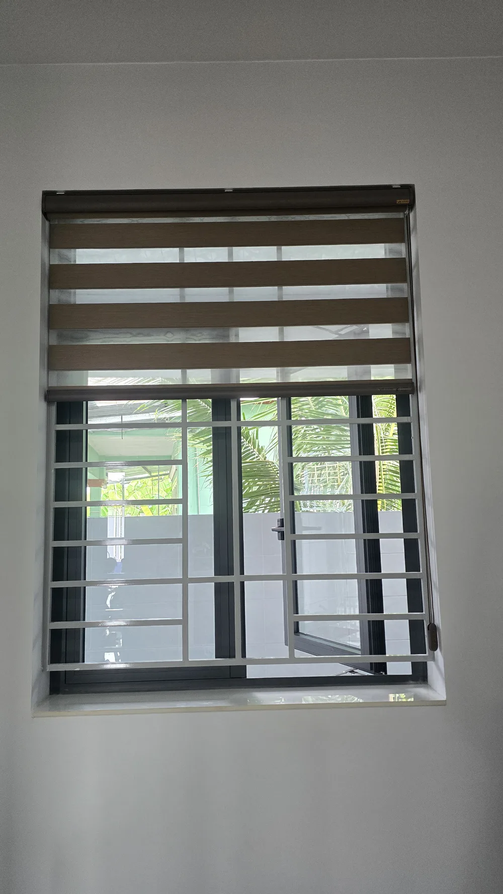 Brown and white zebra blinds installed on townhouse bedroom windows